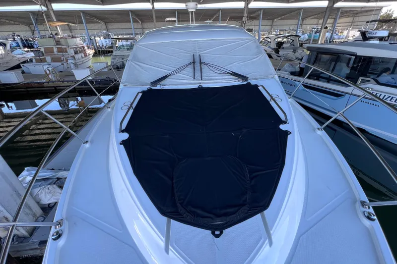Slide: The Image of 2017 Sea Ray Sundancer 400 yacht docked in a marina under a covered shelter. - 94