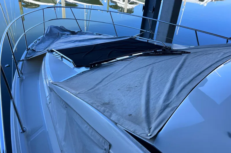 Slide: The Image of 2017 Sea Ray Sundancer 400 yacht with covered deck, docked in marina. - 95