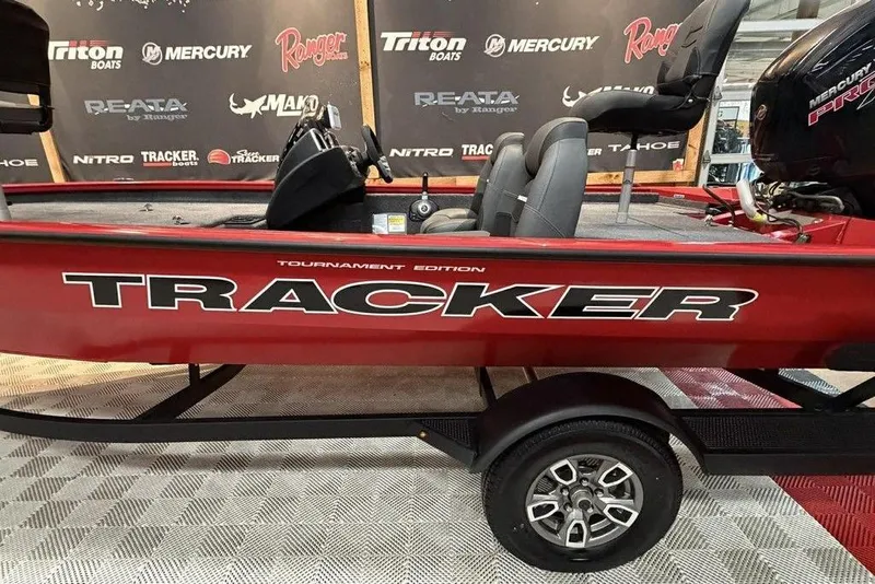 Slide: The Image of 2026 Tracker Pro Team 190 boat, red, tournament edition, displayed indoors. - 12