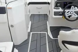 Slide: The Image of 2022 Bayliner DX 2250 boat interior with modern steering and sleek flooring design. - 2