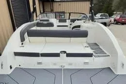 Slide: The Image of 2022 Bayliner DX 2250 boat, spacious seating, modern design, parked outdoors. - 4