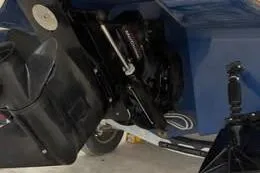 Slide: The Image of 2022 Bayliner DX 2250 boat engine and propeller detail in a garage setting. - 5