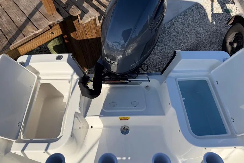 Slide: The Image of 2026 Key West 1720 Center Console boat with open storage compartments and outboard motor. - 10