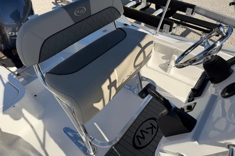 Slide: The Image of 2026 Key West 1720 Center Console boat interior with steering wheel and seating. - 15