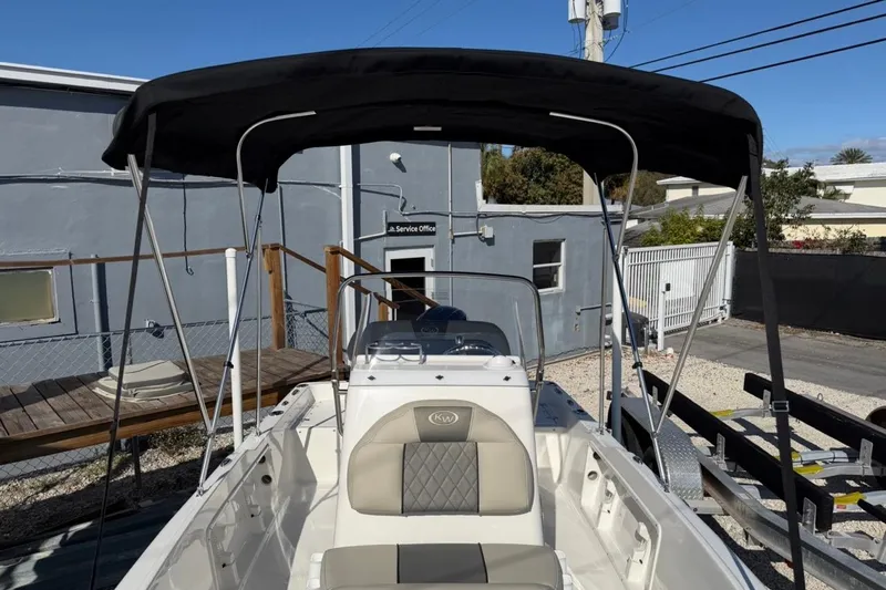 Slide: The Image of 2026 Key West 1720 Center Console boat with canopy in a service area. - 16