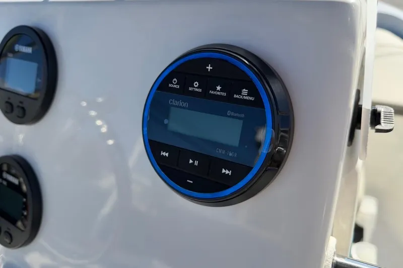 Slide: The Image of 2026 Key West 1720 Center Console dashboard with Clarion audio system and controls. - 21