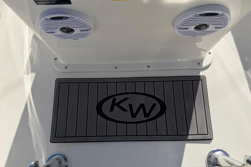 Slide: The Image of 2026 Key West 1720 Center Console boat deck with KW logo mat and speakers. - 31