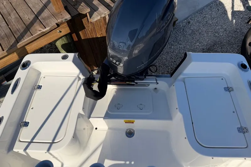 Slide: The Image of 2026 Key West 1720 Center Console boat with outboard motor, docked on gravel. - 9