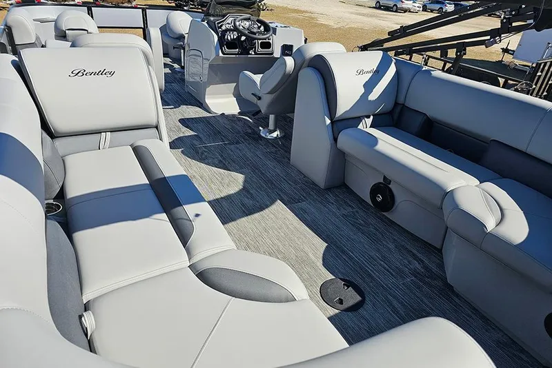 Slide: The Image of 2026 Bentley Pontoons 243 Fish CWT interior with luxurious gray seating and modern dashboard. - 10