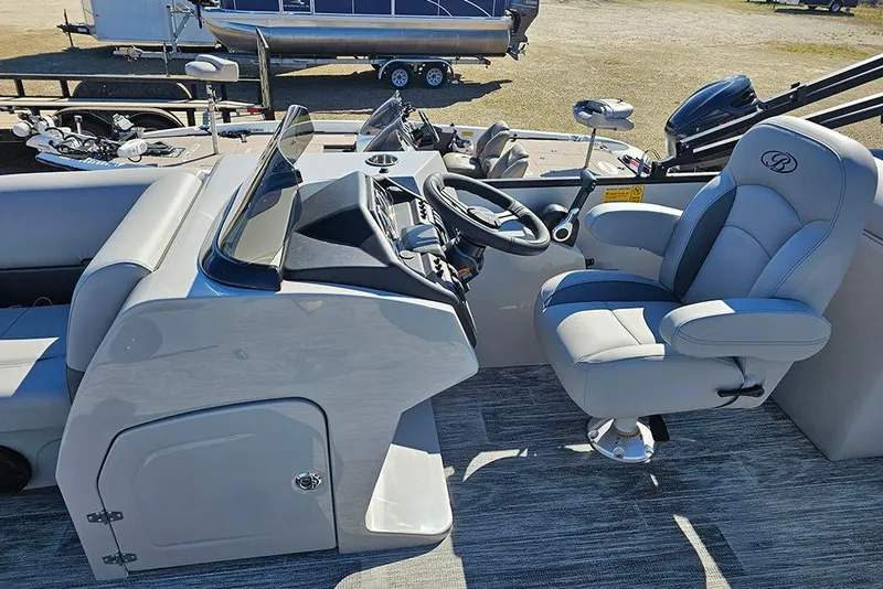 Slide: The Image of 2026 Bentley Pontoons 243 Fish CWT interior with steering console and captain's chair. - 17