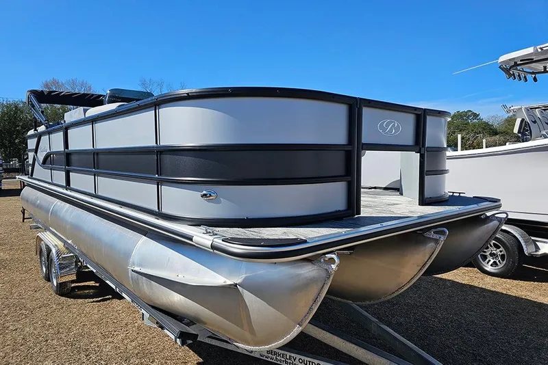 Slide: The Image of 2026 Bentley Pontoons 243 Fish CWT on trailer, sleek design under clear blue sky. - 5