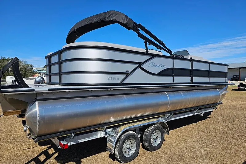 Slide: The Image of 2026 Bentley Pontoons 243 Fish CWT on trailer, sleek design under clear blue sky. - 7