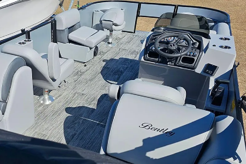 Slide: The Image of 2026 Bentley Pontoons 243 Fish CWT interior with modern seating and steering console. - 9