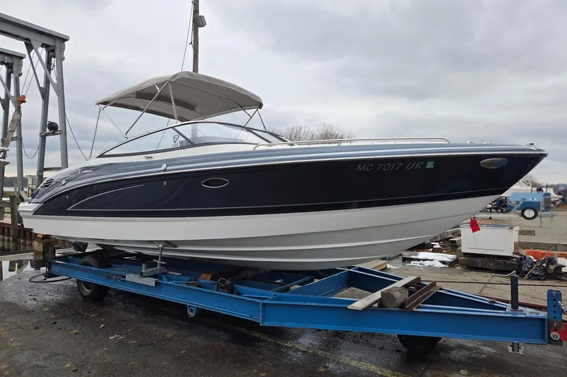 The Image of 2022 Formula 270 Bowrider boat on trailer, featuring sleek design and canopy. - 1