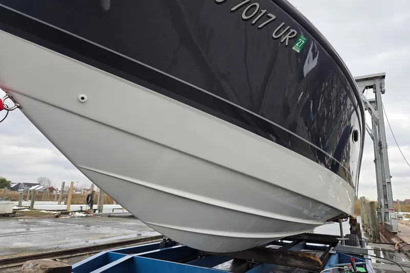 Slide: The Image of 2022 Formula 270 Bowrider boat on a lift, showcasing sleek hull design. - 11