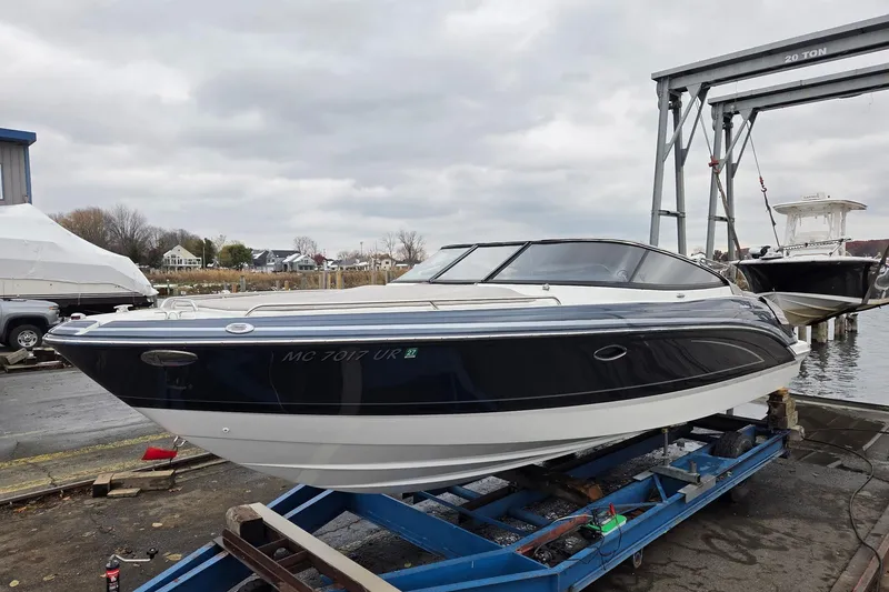 Slide: The Image of 2022 Formula 270 Bowrider boat on trailer at marina, overcast sky. - 13