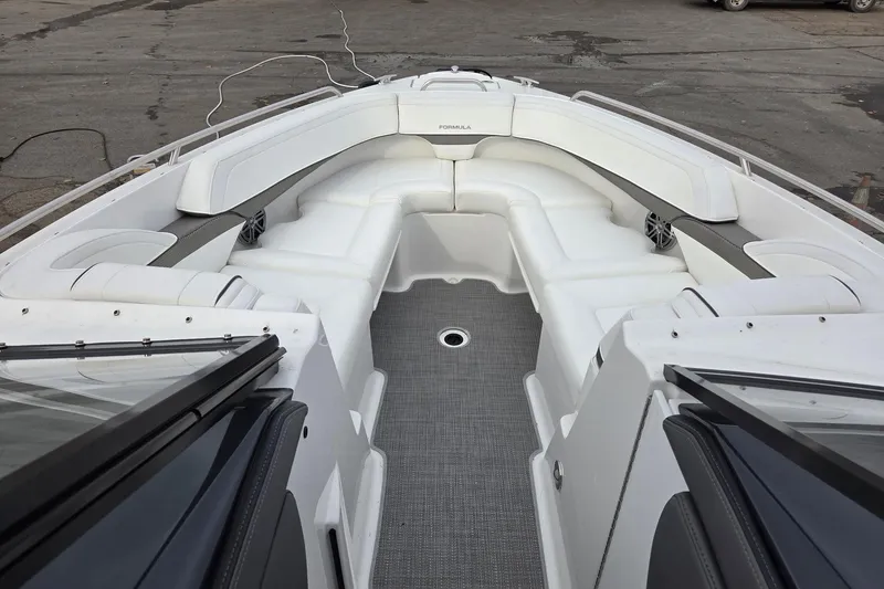 Slide: The Image of 2022 Formula 270 Bowrider boat interior with white seating and gray flooring. - 17