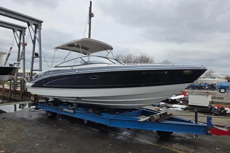 Slide: The Image of 2022 Formula 270 Bowrider on trailer at marina, overcast sky. - 3