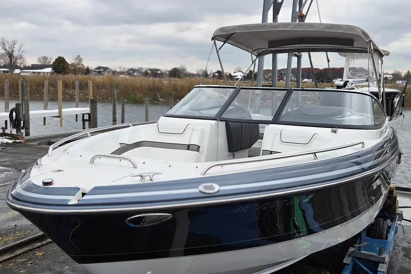 Slide: The Image of 2022 Formula 270 Bowrider boat docked, featuring sleek design and spacious seating. - 4