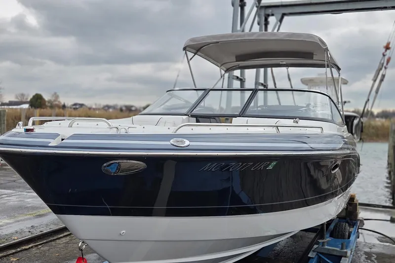 Slide: The Image of 2022 Formula 270 Bowrider boat on a lift, under cloudy skies. - 5