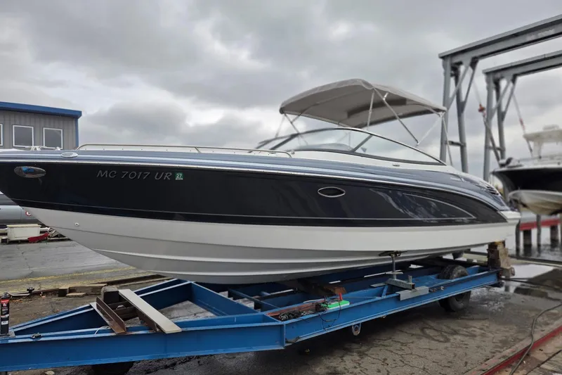 Slide: The Image of 2022 Formula 270 Bowrider on trailer, dockside, under cloudy sky. - 6