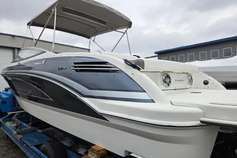 Slide: The Image of 2022 Formula 270 Bowrider boat with sleek design and canopy, displayed outdoors. - 7