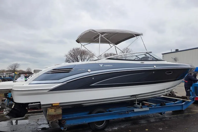 Slide: The Image of 2022 Formula 270 Bowrider boat on trailer, featuring sleek design and canopy. - 8