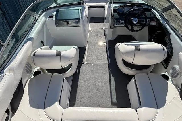 Slide: The Image of 2012 Yamaha Boats SX190 interior with white seating and modern dashboard. - 10