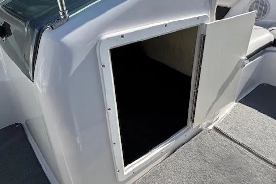 Slide: The Image of 2012 Yamaha Boats SX190 storage compartment with open hatch, showcasing interior space. - 18