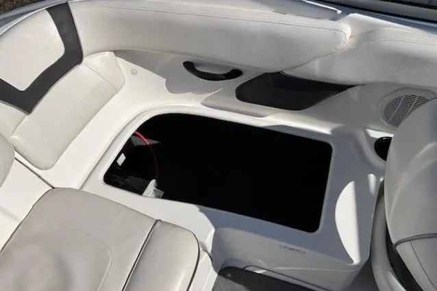 Slide: The Image of Interior view of a 2012 Yamaha Boats SX190, featuring white seating and storage compartment. - 22