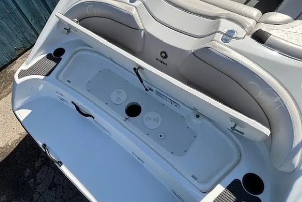 Slide: The Image of 2012 Yamaha Boats SX190 interior storage compartment with seating and cup holders. - 26