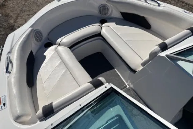 Slide: The Image of 2012 Yamaha Boats SX190 interior with white cushioned seating and speakers. - 7