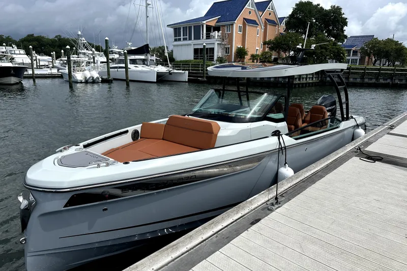 Slide: The Image of 2024 Saxdor 320 GTO boat docked at marina with modern design and sleek features. - 1