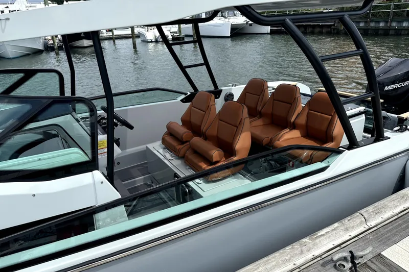 Slide: The Image of 2024 Saxdor 320 GTO boat with luxurious seating, docked at a marina. - 3