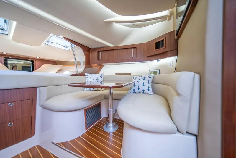 Slide: The Image of Luxurious interior of 2019 Grady-White Express boat with cozy seating and elegant wood finishes. - 14