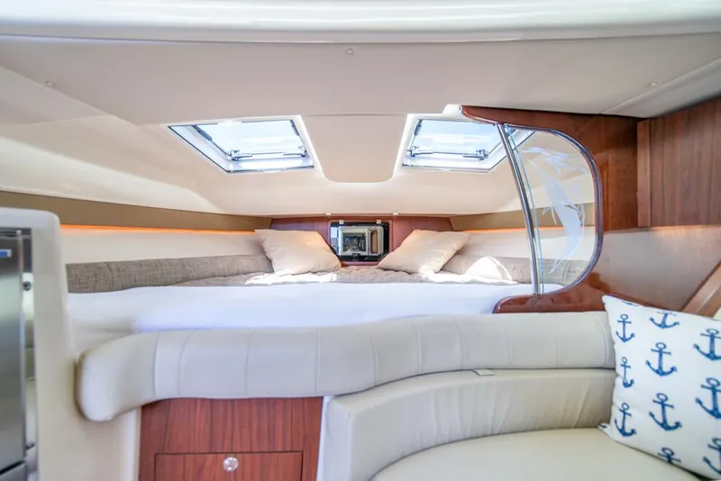 Slide: The Image of Luxurious cabin interior of 2019 Grady-White Express boat with skylights and plush bedding. - 19