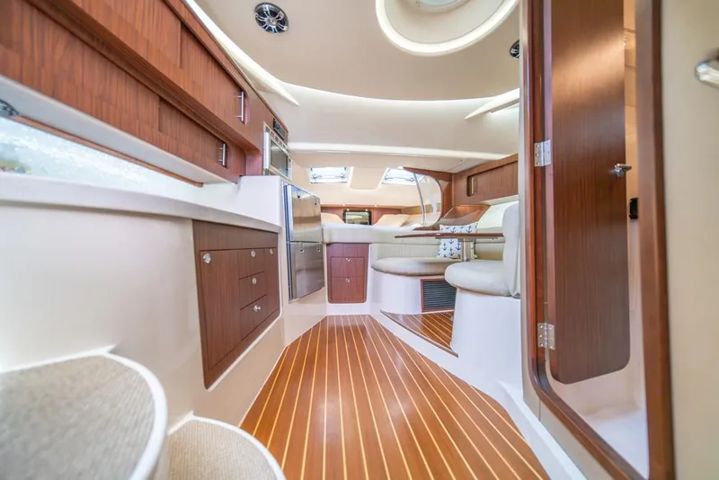 Slide: The Image of Luxurious interior of 2019 Grady-White Express boat with wood accents and modern amenities. - 24