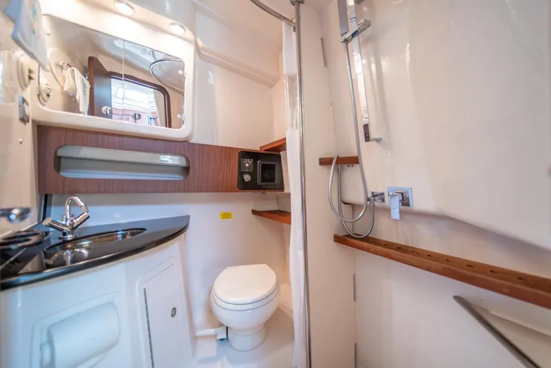Slide: The Image of 2019 Grady-White Express boat bathroom with sink, toilet, and shower. - 25