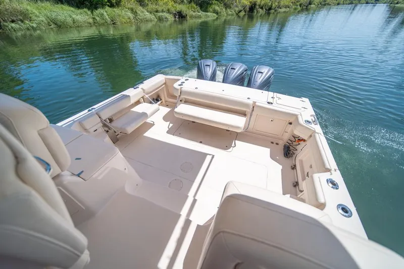 Slide: The Image of 2019 Grady-White Express boat interior with seating, on a calm river. - 26