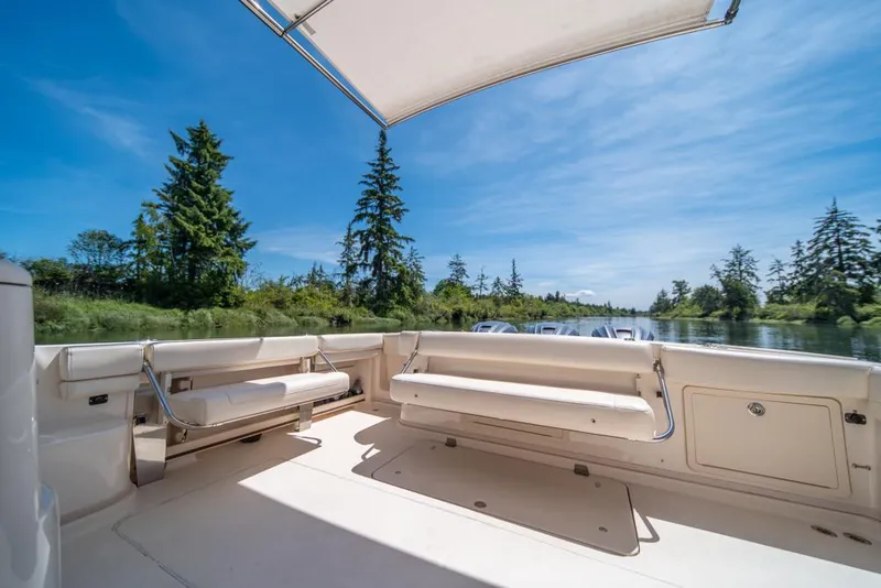 Slide: The Image of 2019 Grady-White Express boat interior with scenic river view and clear blue sky. - 33