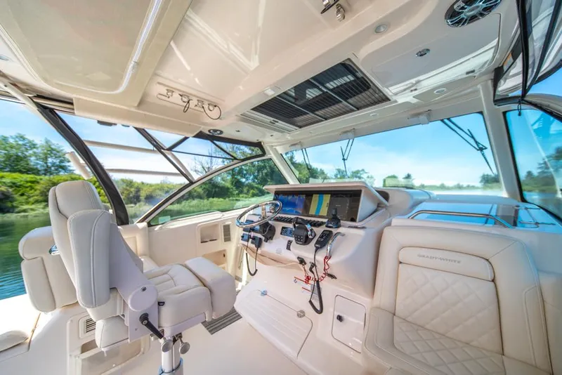 Slide: The Image of 2019 Grady-White Express boat interior with modern helm and luxurious seating. - 37