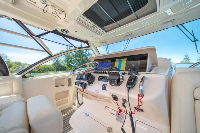 Slide: The Image of 2019 Grady-White Express boat cockpit with modern navigation equipment and luxurious seating. - 38