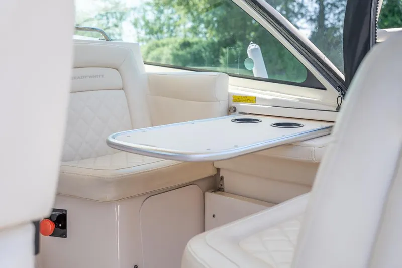 Slide: The Image of 2019 Grady-White Express boat interior with beige seating and table. - 41