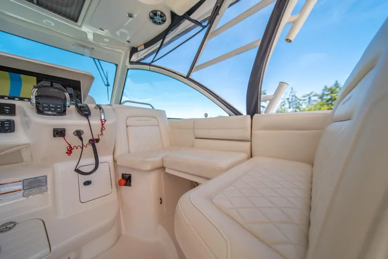 Slide: The Image of 2019 Grady-White Express boat interior with plush seating and control panel. - 42
