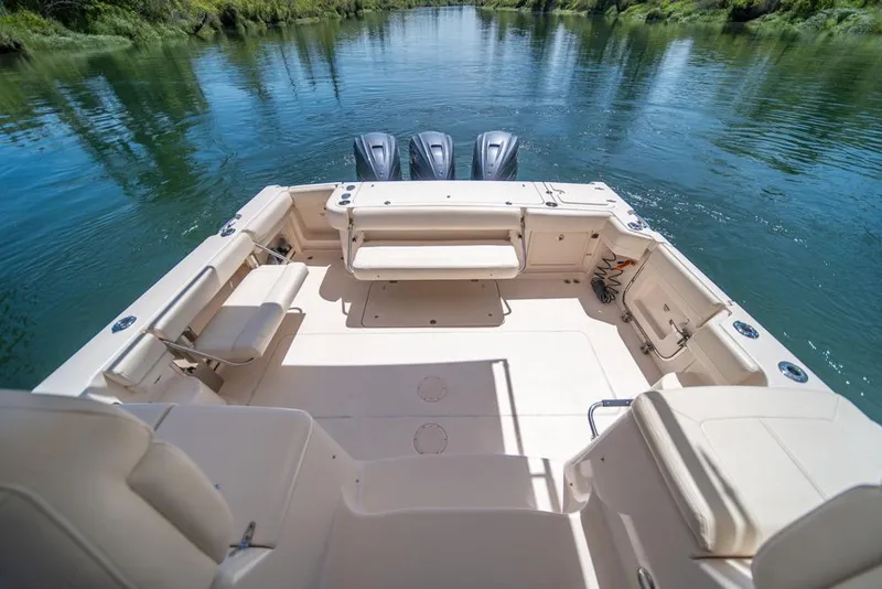 Slide: The Image of 2019 Grady-White Express boat interior with seating, on a calm river. - 44