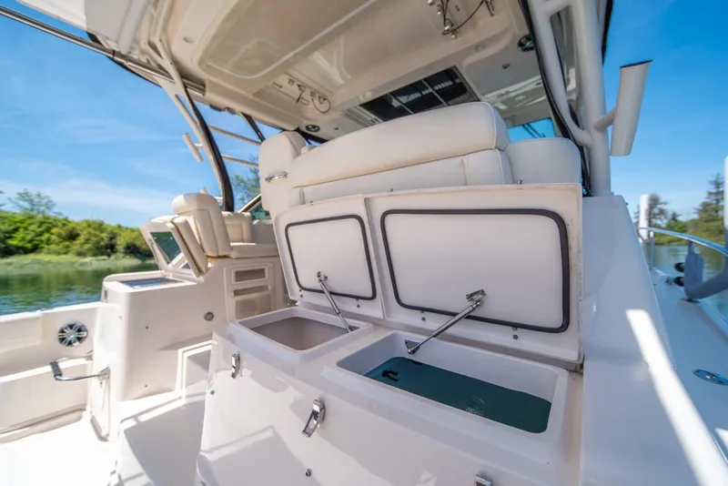 Slide: The Image of 2019 Grady-White Express boat interior with open storage compartments, sunny day. - 46