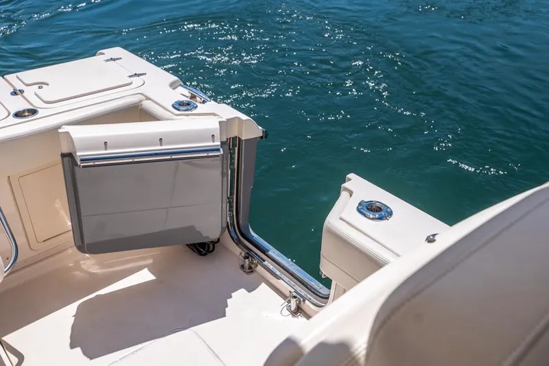Slide: The Image of 2019 Grady-White Express boat deck with open transom door, overlooking blue water. - 48