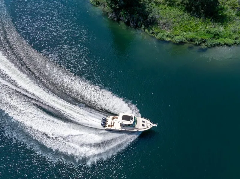 Slide: The Image of Aerial view of 2019 Grady-White Express boat cruising on a scenic waterway. - 9