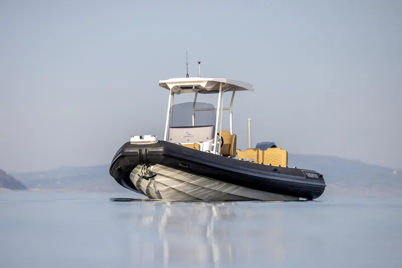 Slide: The Image of 2026 Highfield Sport 800 boat on calm water, showcasing sleek design and modern features. - 11