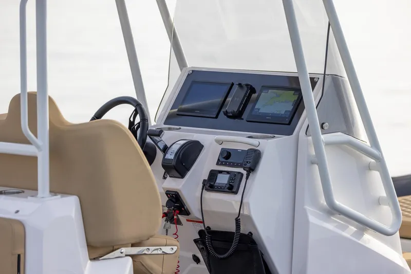 Slide: The Image of 2026 Highfield Sport 800 boat dashboard with navigation screens and controls. - 12
